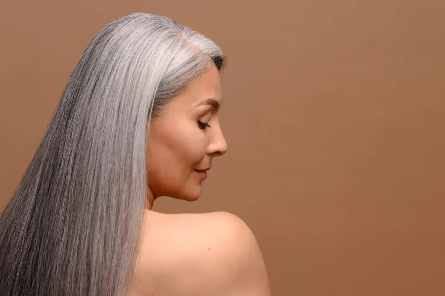 A woman with long, sleek silver-gray hair